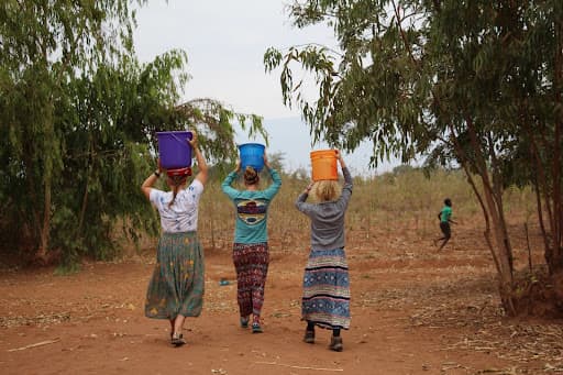 Community members carrying water